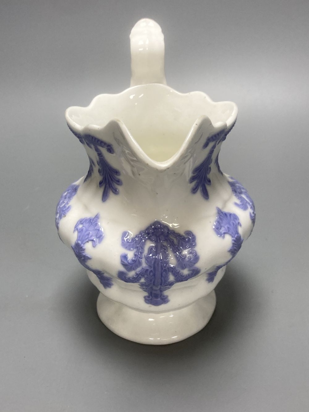 Four early 19th century Staffordshire jugs, each with lilac coloured floral applied panels, one dated 1826, tallest 22cm